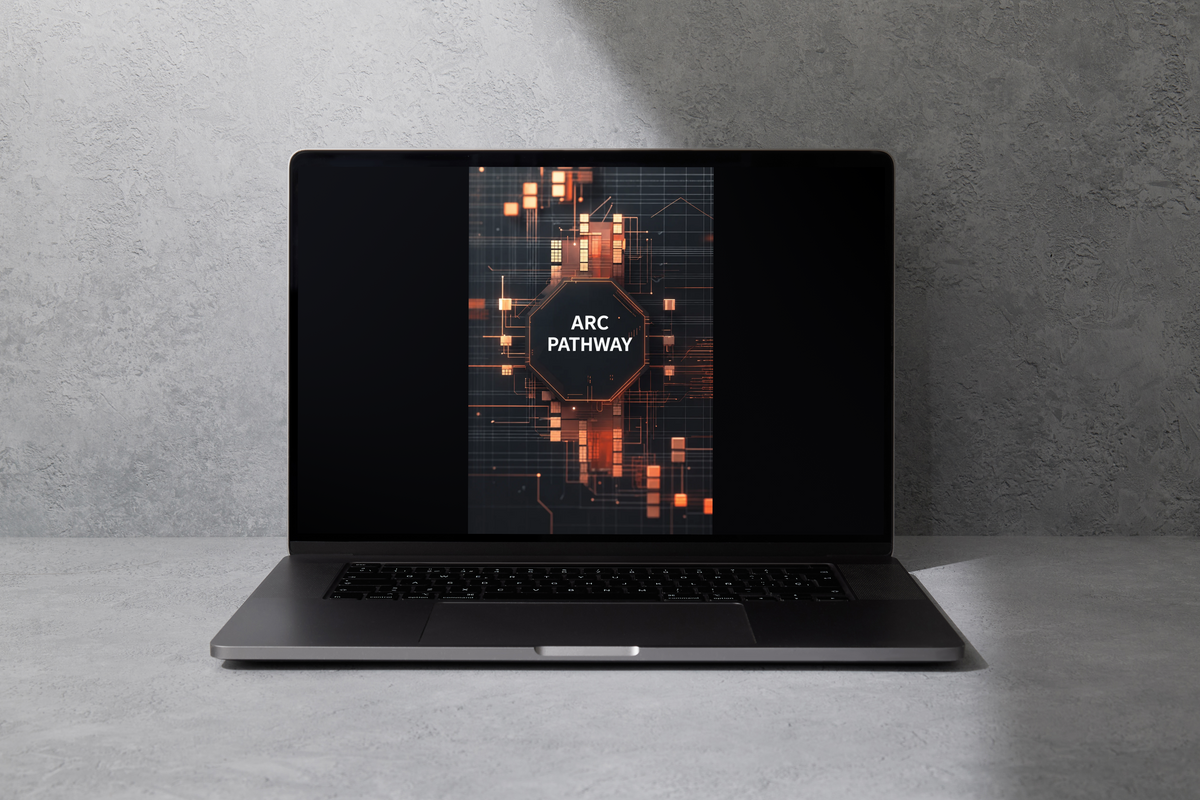 A dark gray laptop sits open on a light gray concrete surface against a textured gray wall. The laptop screen displays a digital graphic with the text 'FLOW MODULE' over a glowing orange and dark circuit-board design.